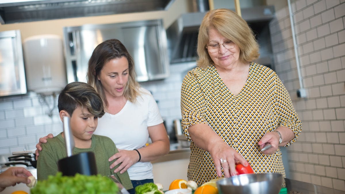 A family enjoys a cooking session together in a contemporary kitchen in Portugal.